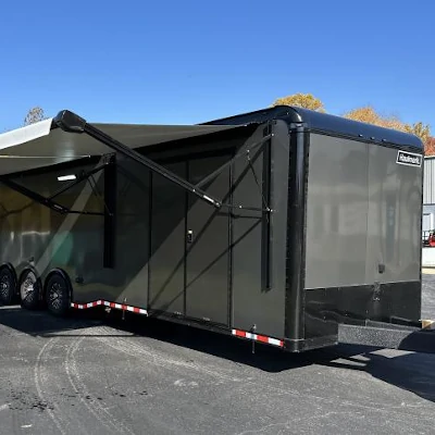 Small enclosed toy hauler trailer with a rear ramp door